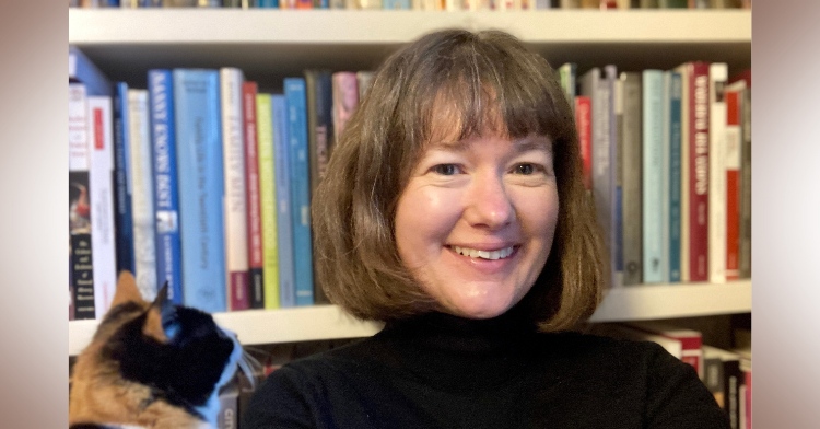 A photo of guest Prof Jane Hamlett smiling into camera with a shelf of books behind her