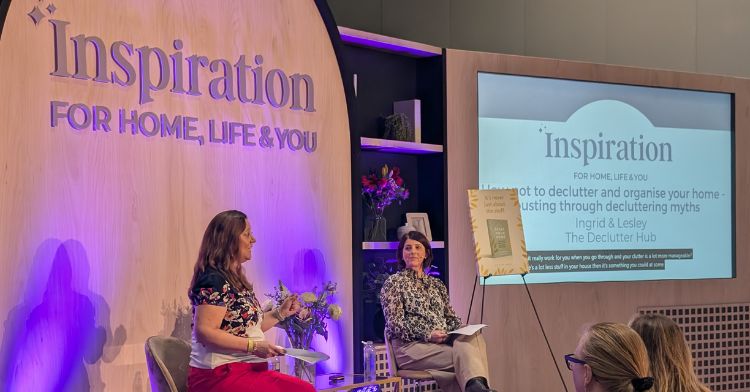image shows ingrid and lesley facing each other on a stage whilst giving a talk