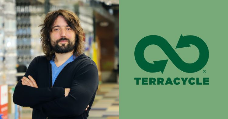 image shows the owner of terracycle smiling. he has long brown hair.